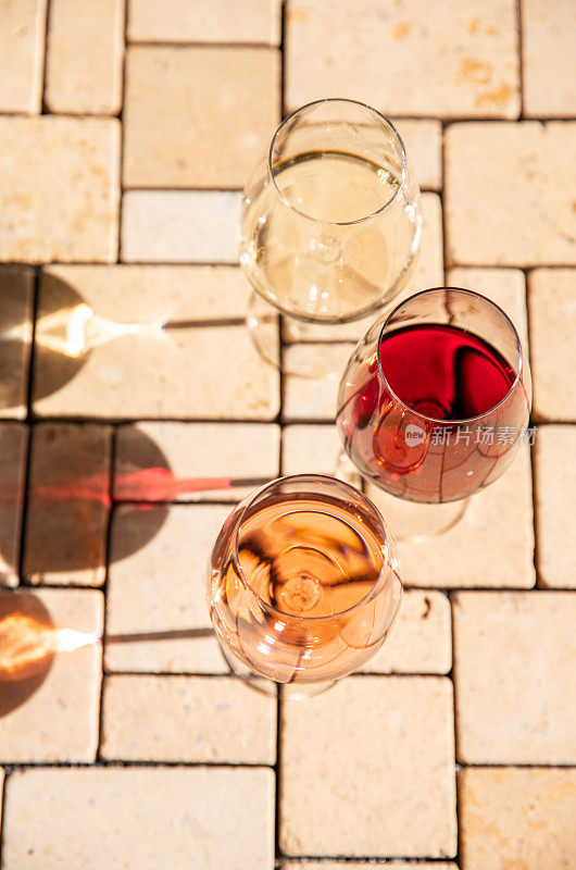 Wine glass variety with red, white and rosé wine at vineyard wine tasting in sunlight